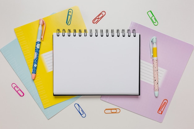 Notepad, exercise book and pen on the desk. Mock up in copy space office on white background. Back to school