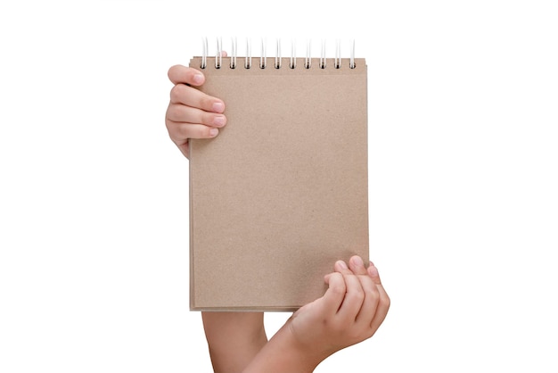 Notepad isolated on white background Brown notepad made from recycled paper on a white background in the hands of a child