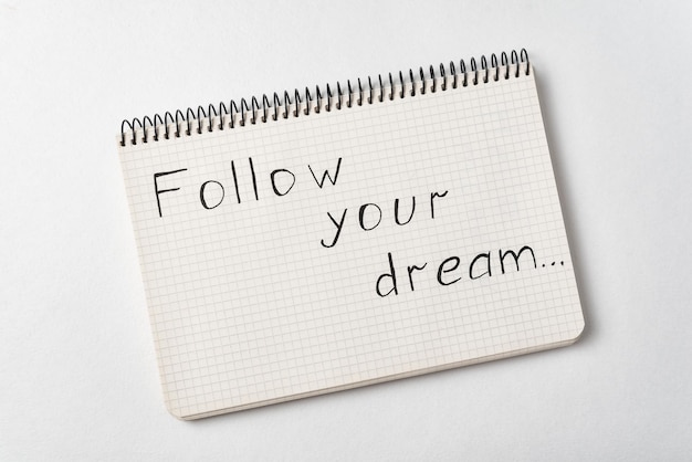 Notepad with the words Follow your dream on white background Handwritten