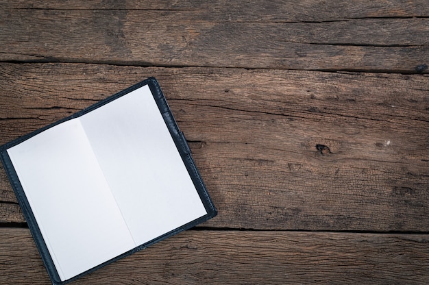 Notepads are placed on a wooden table top view.