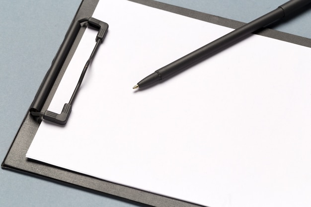 Notes clipboard with pen and blank sheets of paper