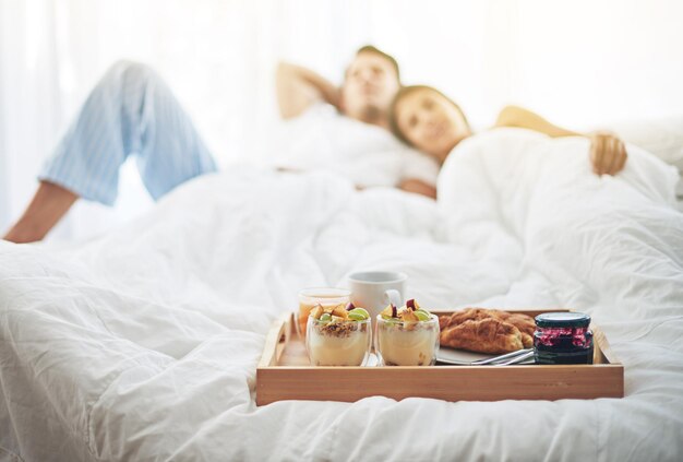 Nothing better than breakfast in bed Shot of a loving young couple enjoying breakfast in bed