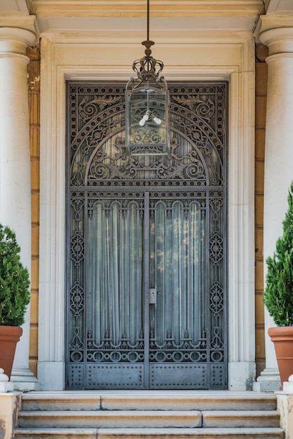 Noucentista porch with ornate cast-iron door