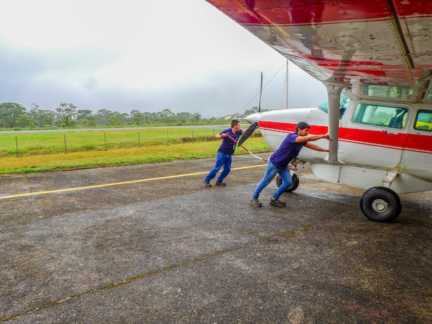 Nov 4 2021, Shell, Pastaza, Ecuador. Mechanics working on a light aircraft in the Amazon Region of Ecuador