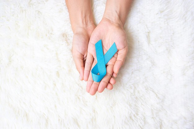 November Prostate Cancer Awareness month, Man holding light Blue Ribbon for supporting people living and illness. Healthcare, International men, Father, World cancer day and world diabetes day concept