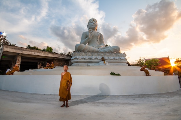 Novice buddhist monk of Buddha statue at Thailand