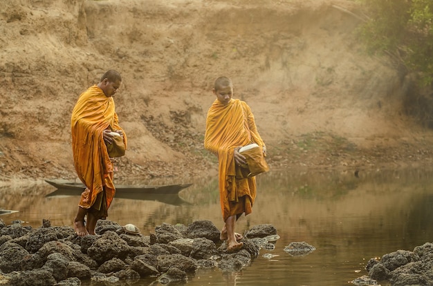 Novice buddhist monk of Buddha statue at Thailand