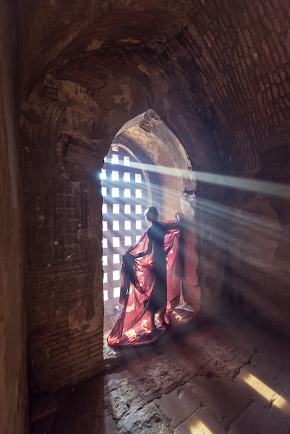 Novice monk standing in ancient temple