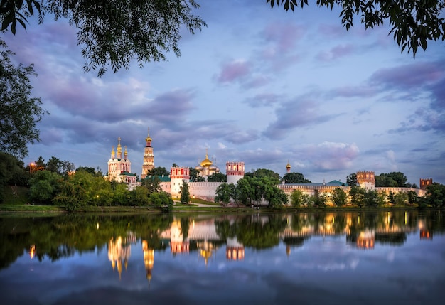 Novodevichy Convent with reflection in a pond in Moscow on a summer evening