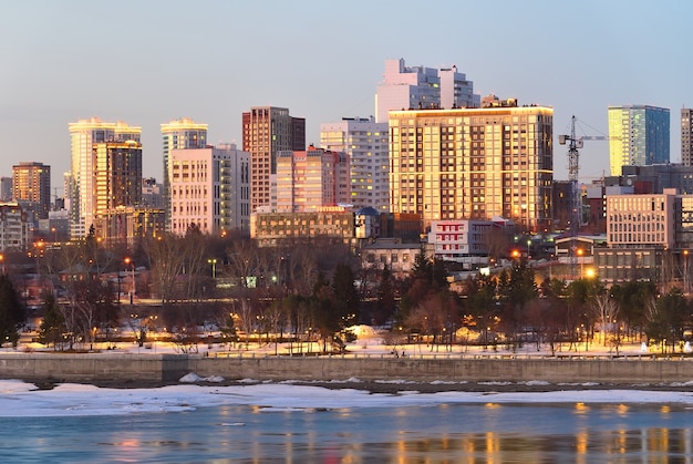 Novosibirsk embankment in the evening High multistorey buildings of the city center on the Bank