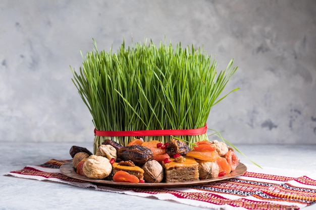 Novruz setting table decoration,  wheat grass, Azerbaijan national pastry pakhlava, new year sring celebration, nature awakening