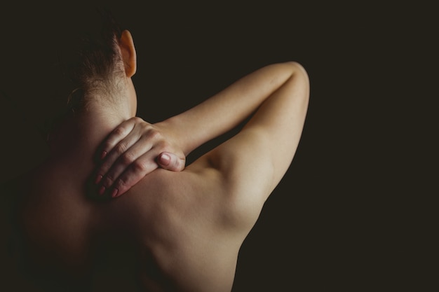 Nude woman with a neck injury