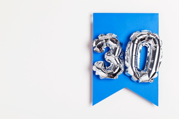 Photo number 30 silver balloon celebration number on a blue banner