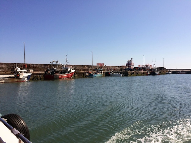 A number of fishing boats are moored near the sea pier View from the ship from the sea side