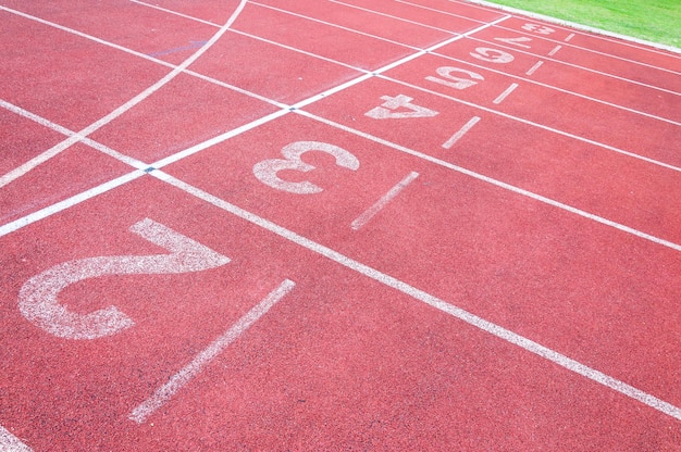 Numbers starting point on red running trackrunning track and green grassDirect athletics Running track at Sport Stadium