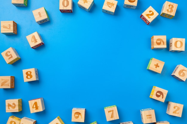 Numbers. Wooden colorful alphabet blocks on blue background, flat lay, top view. 