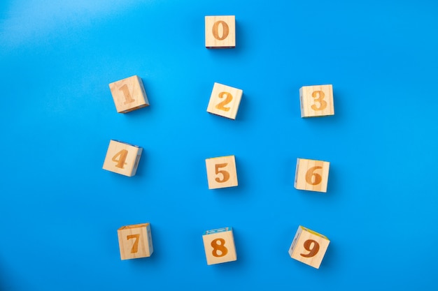 Numbers. Wooden colorful numbers blocks on blue