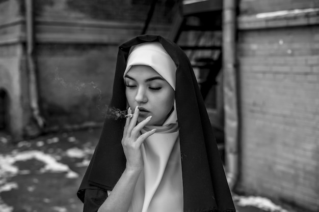 Nun smoking. Portrait of a smoking young nun,