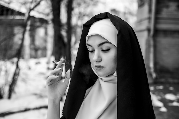 Nun smoking. Portrait of a smoking young nun,