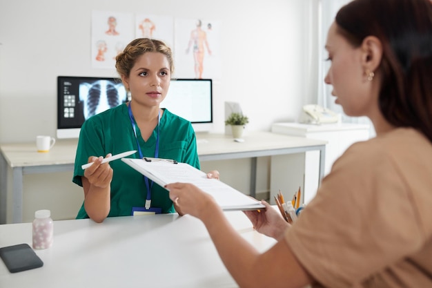 Nurse Asking Patient to Fill Form