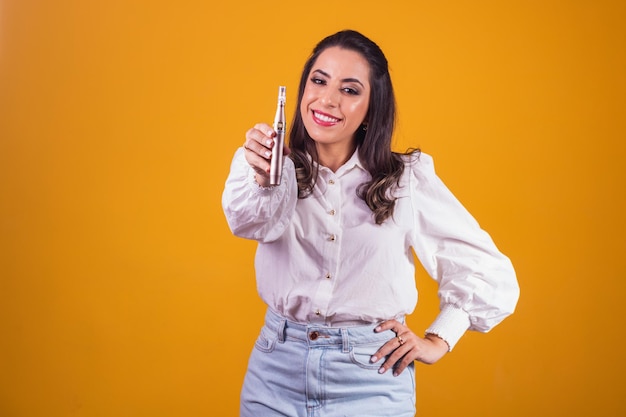 Nurse and beautician holding a dermapen for lip hydration on yellow background.