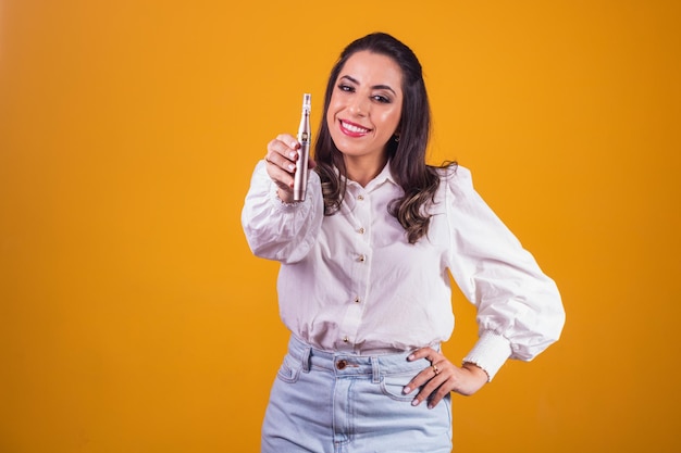 Nurse and beautician holding a dermapen for lip hydration on yellow background.