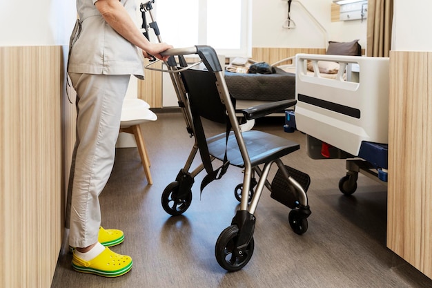 Nurse brought a wheelchair to a stylish hospital room The concept of patient care comfortable movement