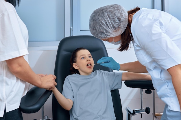 Nurse checks little girl's throat