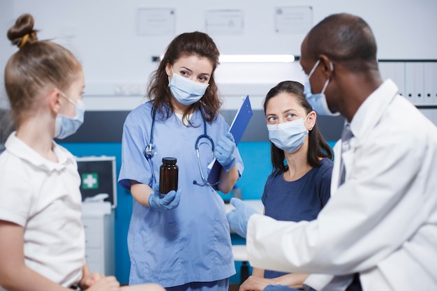 Nurse and doctor shows medication bottle