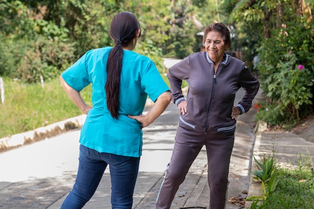 Nurse helps elderly woman maintain an active and healthy life through daily exercises