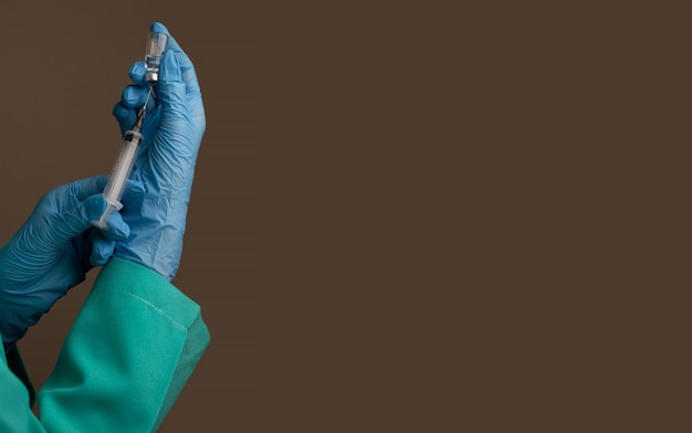 Nurse holding a syringe filled with a medication