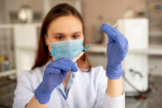 The nurse opens the syringe before the injection