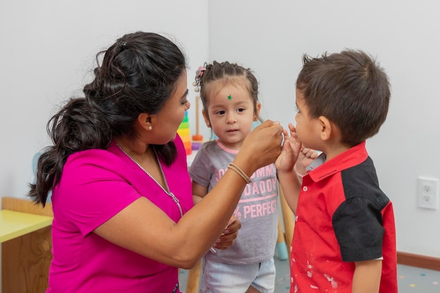 Nurse placing a star on a child's forehead for good behavior in her office