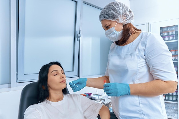 A nurse takes a pcr test from a woman