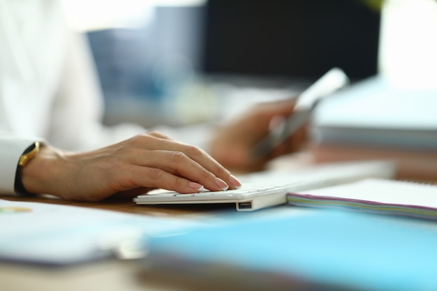 Nurse type text. Woman in white coat hold her hand on white keyboard.