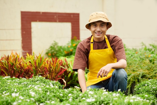 Nursery Owner Working with Plants