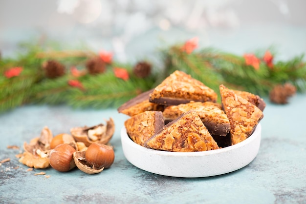 Nut corner triangles, traditional german sweets called Nussecke, covered with chocolate, christmas