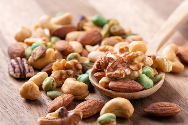 Nut mix on wooden spoon, Assorted and various of nuts.