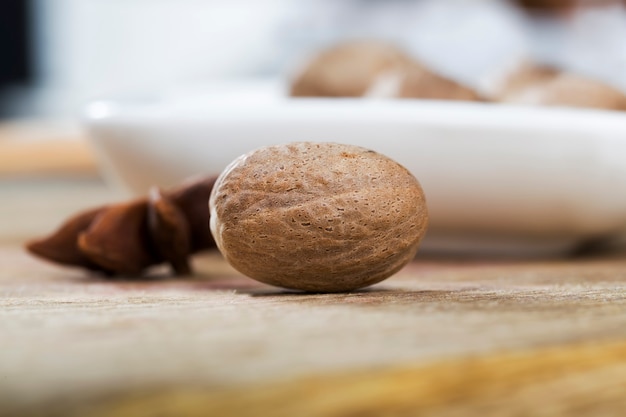 Nutmeg scattered on an old wooden table in the kitchen