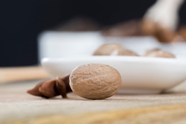 Nutmeg scattered on an old wooden table in the kitchen