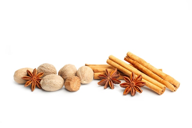 Nutmegs star anise and cinnamon sticks on a white background with copy space