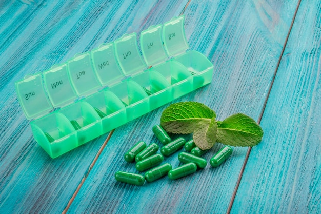 Nutritional supplements in capsules on a wooden background