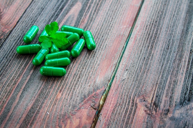 Nutritional supplements in capsules on a wooden background