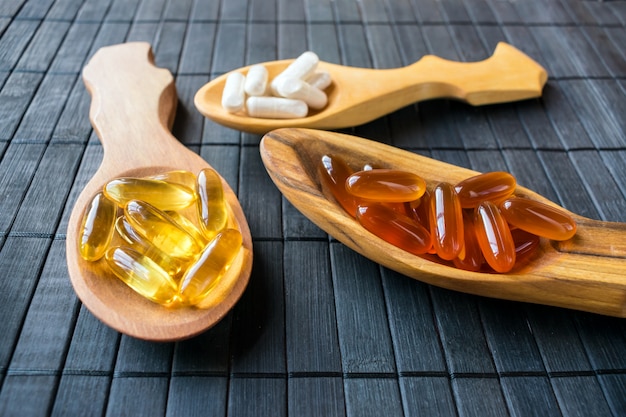 Nutritional supplements and vitamins for brain in three wooden spoons