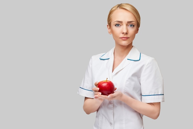 nutritionist doctor healthy lifestyle concept - holding organic red apple