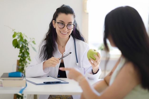 Nutritionist giving consultation about diet plan and healthy eating to the patient