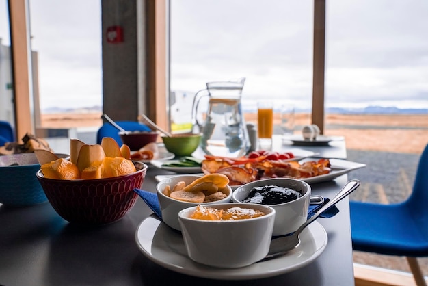 Nutritious breakfast served on table against window with view at luxurious hotel