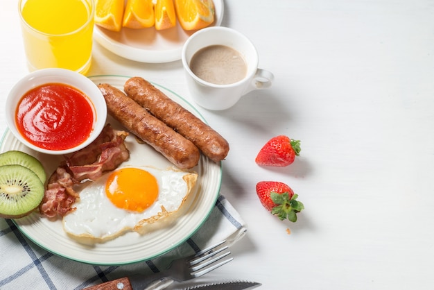 Nutritious breakfast, strawberry, bread, coffee orange juice, sausage, egg