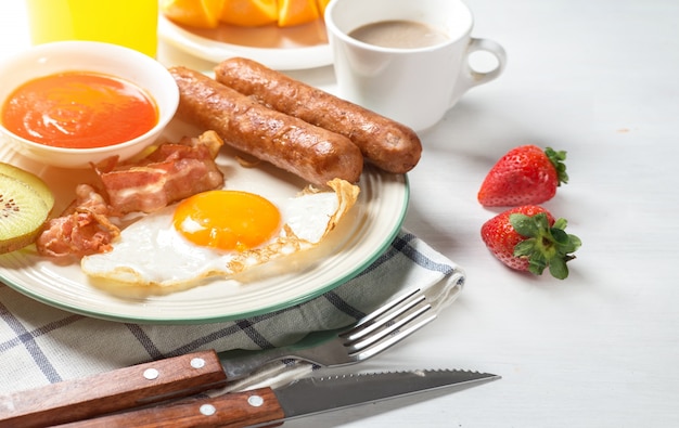 Nutritious breakfast, strawberry, bread, coffee orange juice, sausage, egg