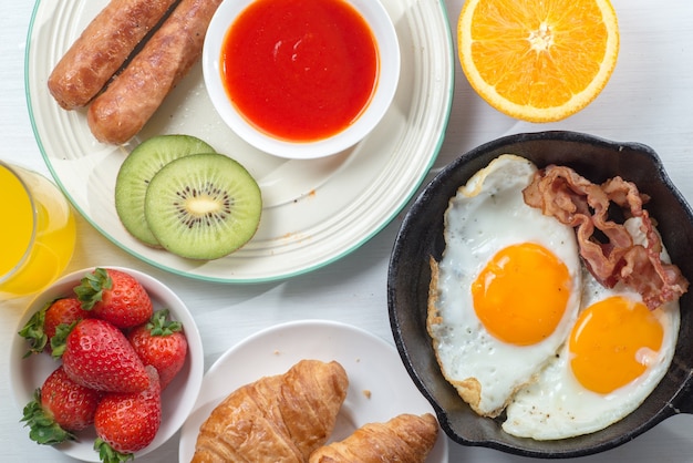 Nutritious breakfast, strawberry, bread, coffee orange juice, sausage, egg